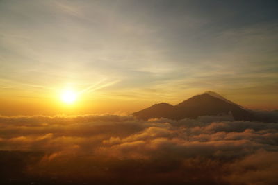 Scenic view of silhouette mountains against sky during sunset