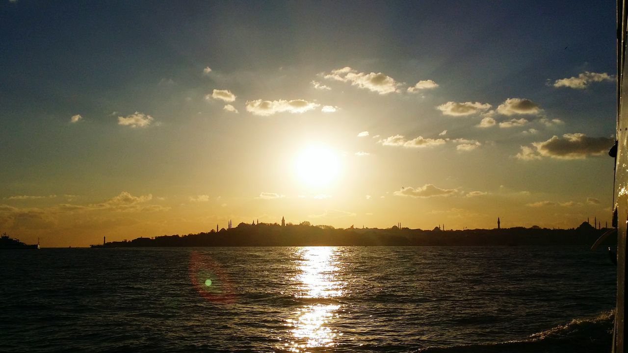 sunset, water, waterfront, sun, reflection, sky, silhouette, scenics, tranquil scene, tranquility, beauty in nature, sunlight, rippled, nature, sea, idyllic, river, orange color, sunbeam, cloud - sky