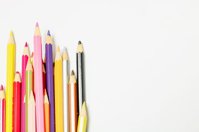 Close-up of colored pencils against white background