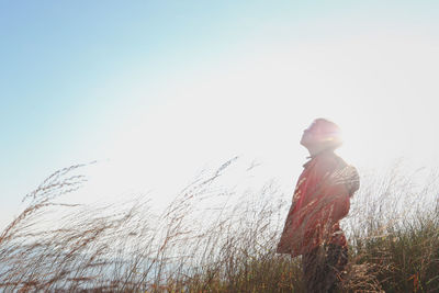 Man standing on field against clear sky