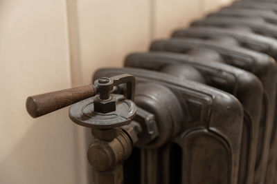 Rusty metal valve of old radiator for temperature regulation in room at home