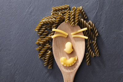 Directly above shot of pastas and spoon on slate