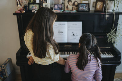 Sisters bonding over playing piano together