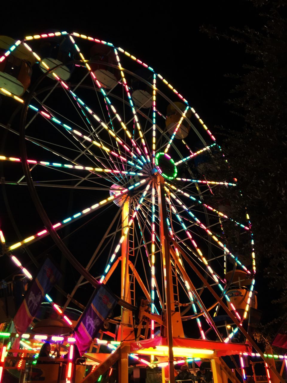 amusement park, amusement park ride, illuminated, arts culture and entertainment, night, ferris wheel, multi colored, low angle view, no people, sky, glowing, outdoors, fairground, spinning, architecture, geometric shape, nature, motion, carnival, enjoyment, nightlife, excitement, stage