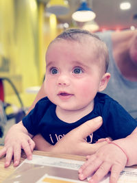 Close-up of cute baby girl at home