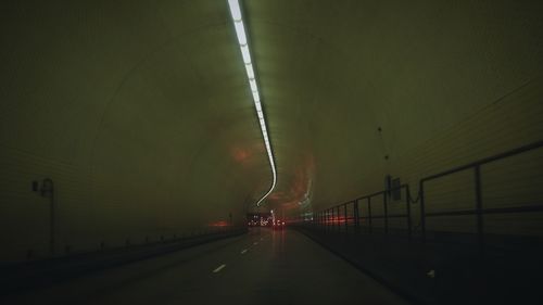 Road in illuminated tunnel