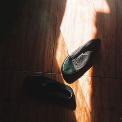 High angle view of shoes on hardwood floor