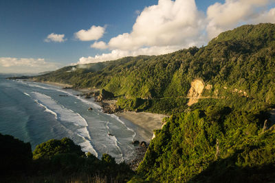 Scenic view of land and sea against sky