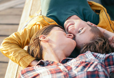 Midsection of couple lying outdoors