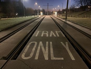 Text on tram line at night