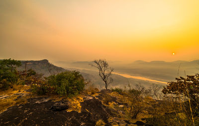 Scenic view of landscape against sky during sunset