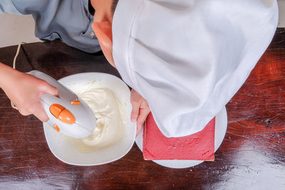 High angle view of man preparing food on table