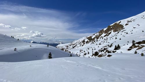 Scenic view of snow covered mountains against sky