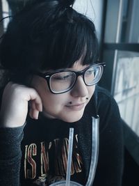 Close-up portrait of teenage boy wearing eyeglasses