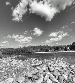 Surface level of stones on land against sky