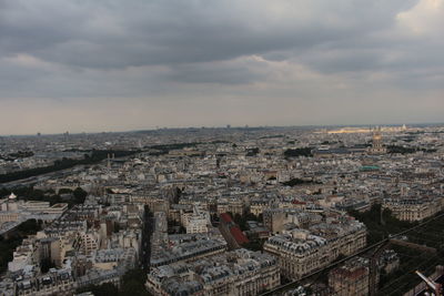 High angle view of buildings in city against cloudy sky