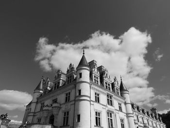 Low angle view of building against cloudy sky