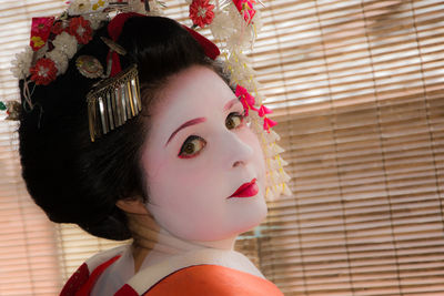 Close-up portrait of young woman looking away