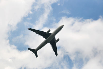 Low angle view of airplane flying in sky