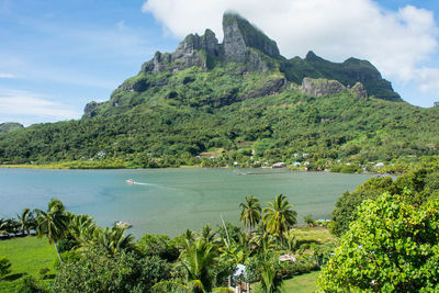 Scenic view of sea and mountains against sky