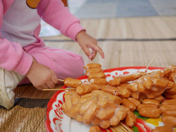 High angle view of woman holding food on table