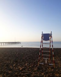 Lifeguard hut on beach against clear sky