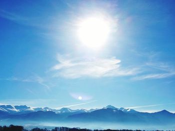 Scenic view of mountains against blue sky