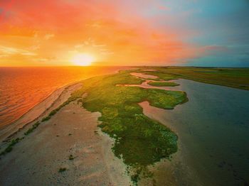 Scenic view of beach against sky during sunset