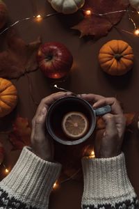 Midsection of person having coffee