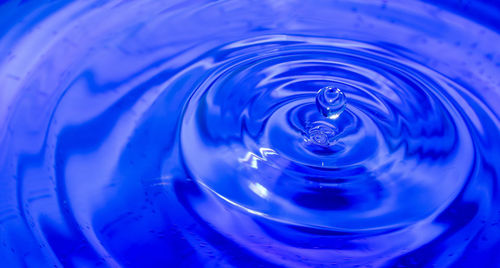 Close-up of water splashing in glass