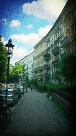 Vehicles on road along buildings