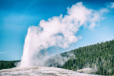 Old faithful geyser erupting in yellowstone national park, usa