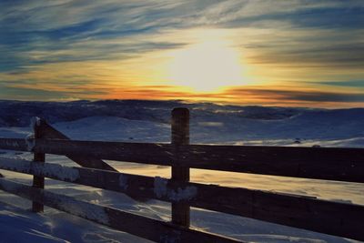 View of railing at sunset
