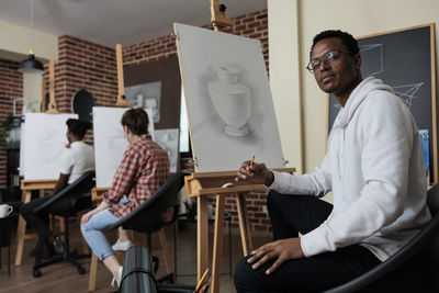 Portrait of young woman using laptop while sitting at home