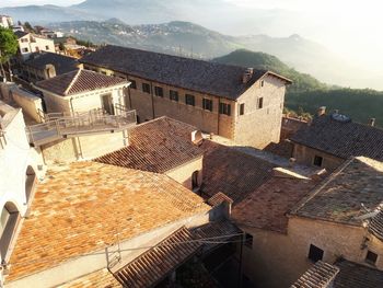 High angle view of houses in town against sky