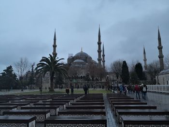 Group of people in temple against sky