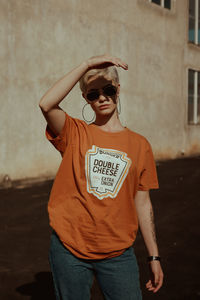 Portrait of young man wearing sunglasses standing outdoors