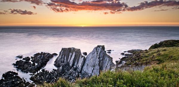 Scenic view of sea against sky during sunset