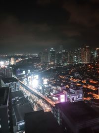 High angle view of illuminated buildings in city at night