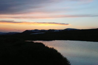 Scenic view of silhouette mountain against sky during sunset