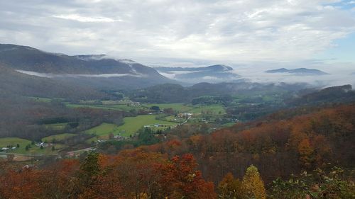 Scenic view of mountains against cloudy sky