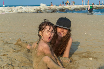 Happy young woman on sand at beach