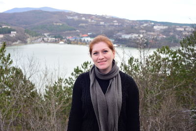 Portrait of smiling young woman standing in water
