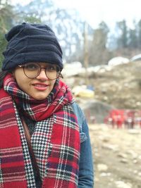 Portrait of smiling woman wearing warm clothing during winter