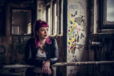 Young woman in abandoned room