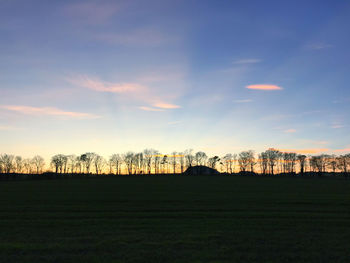 Scenic view of field against sky during sunset