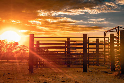 Railing against sky during sunset