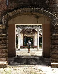 Man walking on corridor of building