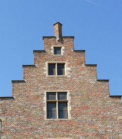 Low angle view of building against clear blue sky