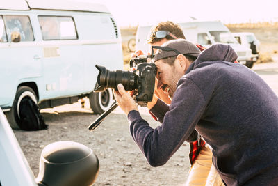 Rear view of man photographing